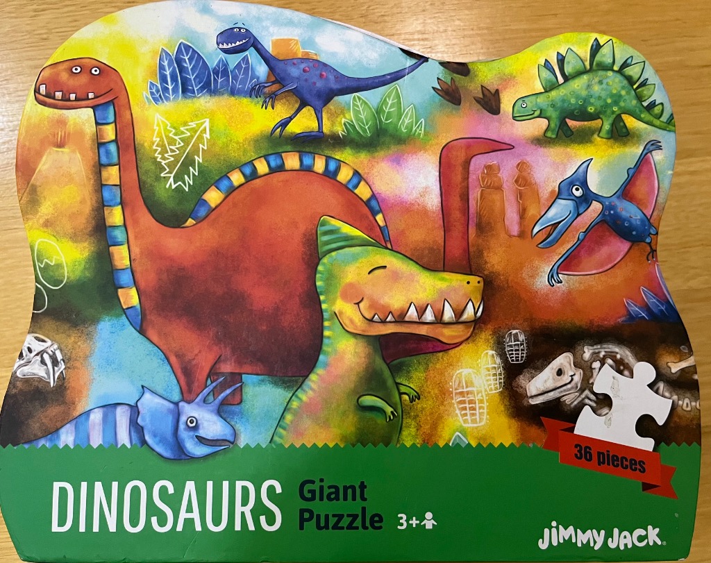 Whimsical illustration of various colorful cartoon dinosaurs in a prehistoric landscape.