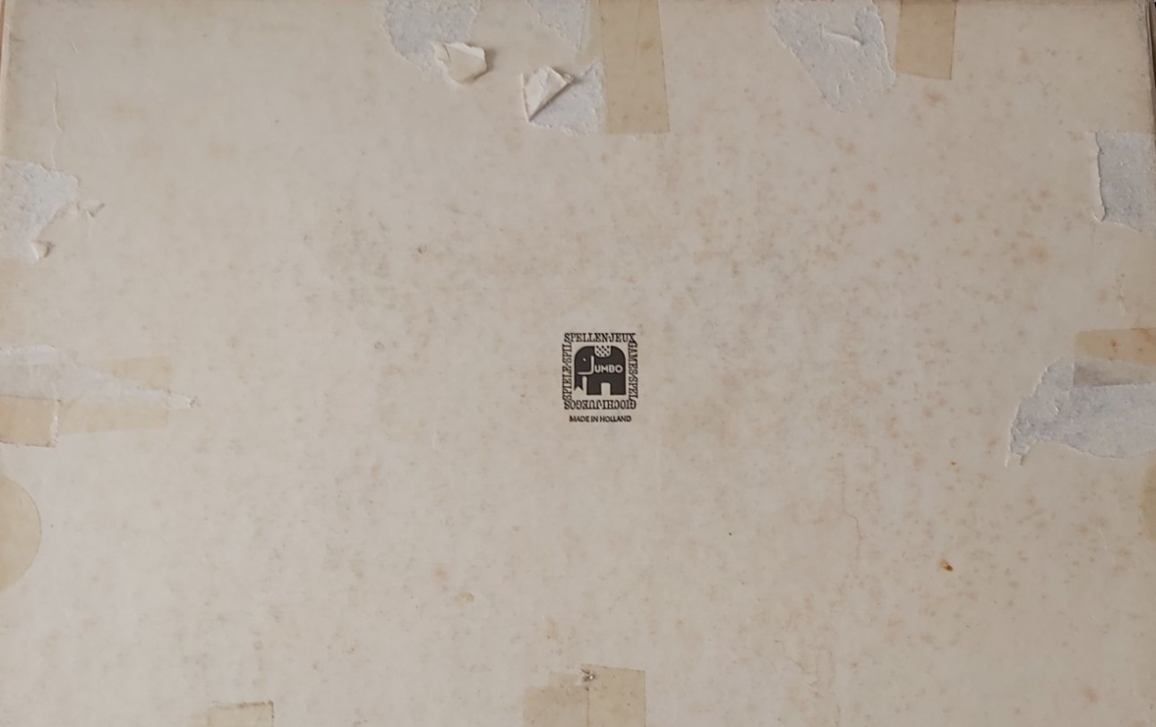 A weathered, off-white surface featuring a centered black elephant logo and remnants of old adhesive tape.