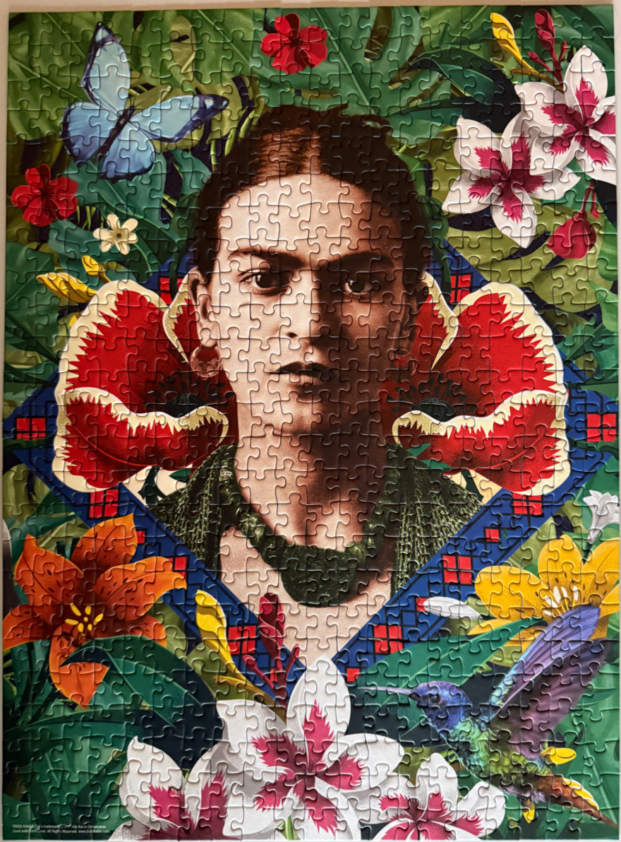 A stylized portrait of Frida Kahlo surrounded by lush tropical flowers, a blue butterfly, and a hummingbird.