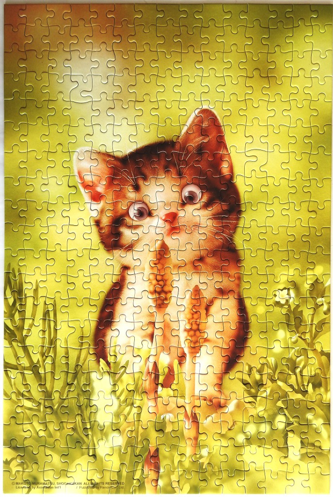 A close-up illustration of a small, wide-eyed tabby kitten peeking through green foliage in a sunlit setting.