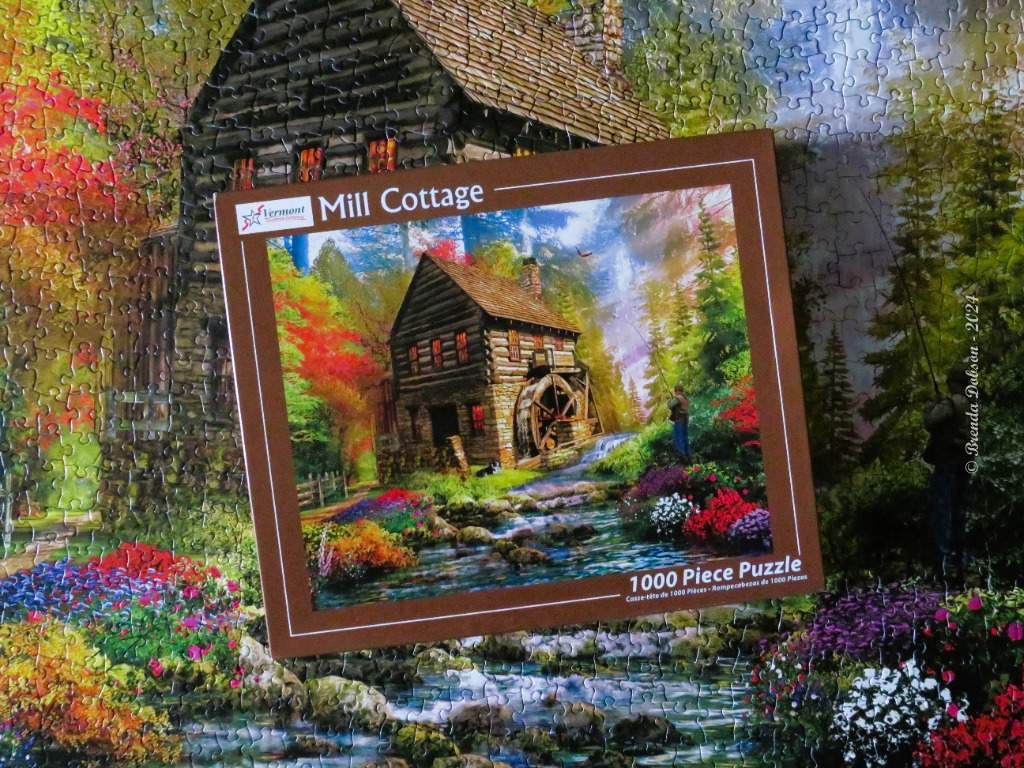 A rustic log cabin with a water wheel beside a stream in a vibrant, sunlit forest.