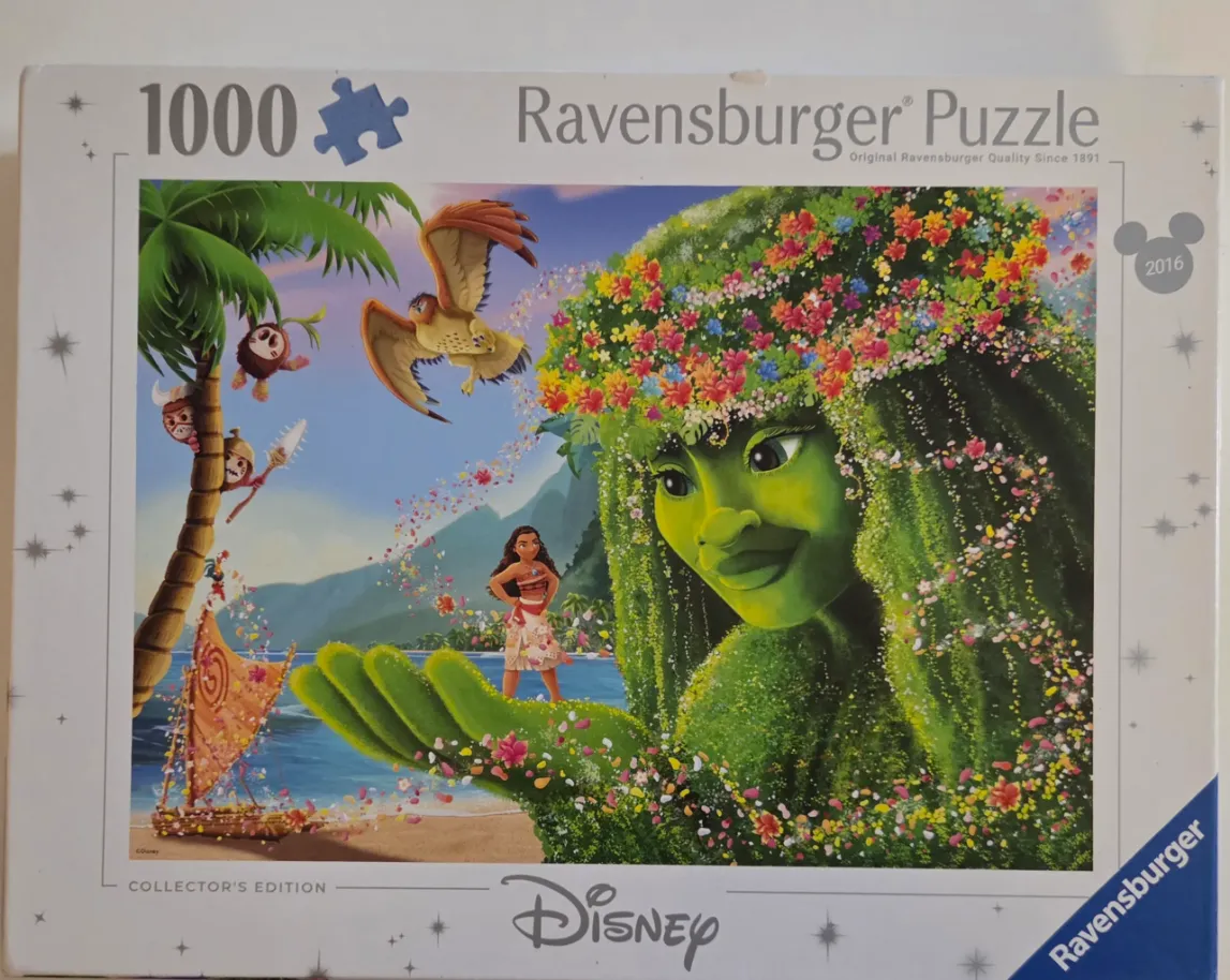 Moana stands on a beach before a giant, flower-crowned Te Fiti goddess made of lush green foliage and flowers.