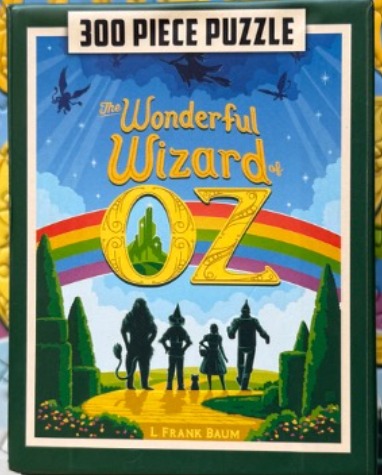 Illustration of Dorothy, the Tin Man, the Scarecrow, and the Cowardly Lion walking down the Yellow Brick Road.