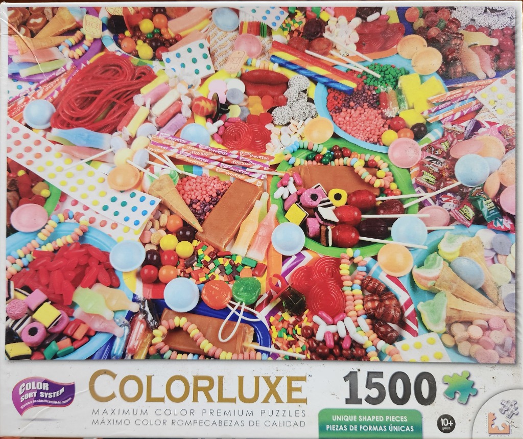 A high-angle, crowded collection of colorful candies, lollipops, jelly sweets, and treats filling the entire frame.