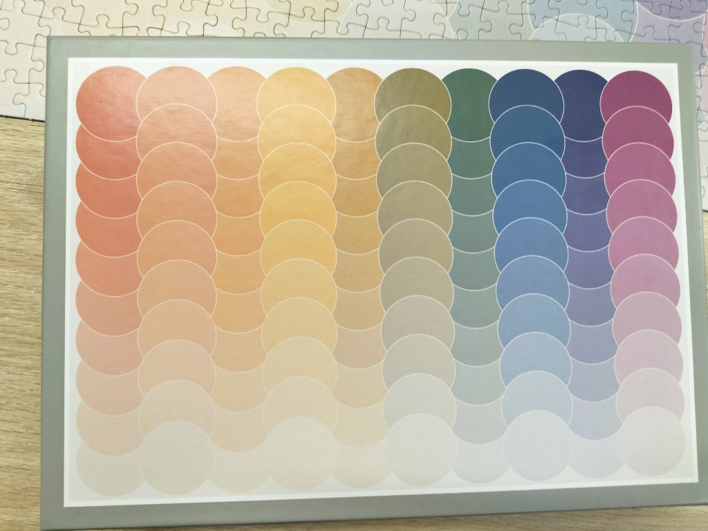 Abstract design of overlapping circles in a gradient of warm and cool tones.