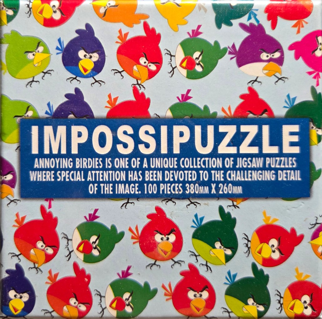 A repeating pattern of colorful, angry cartoon birds on a light blue background.