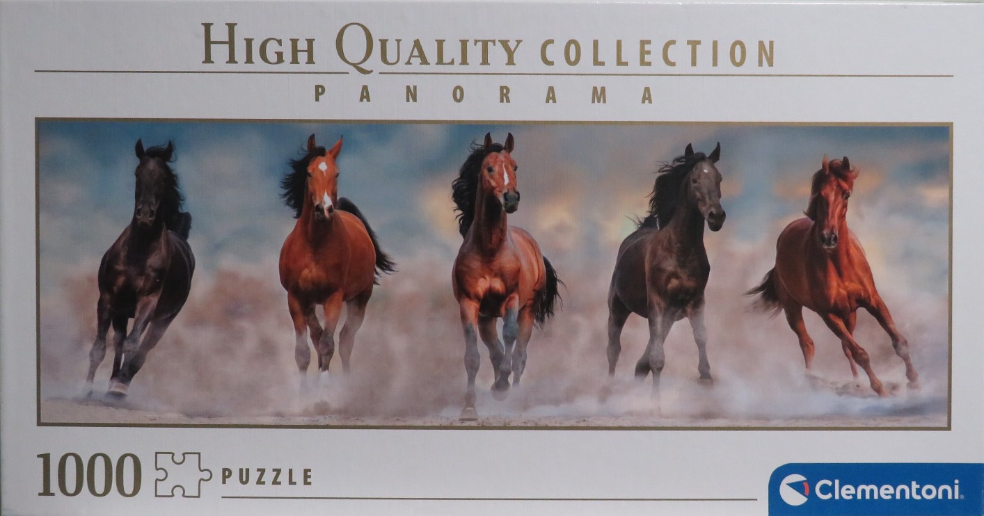 Five horses running through dust in a panoramic landscape.