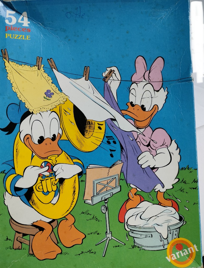 Daisy Duck hangs laundry while Donald Duck plays a tuba on a grassy lawn.