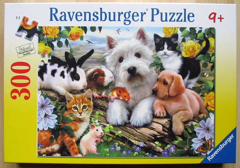 A group of diverse animals including a white terrier, kittens, a puppy, a rabbit, and hamsters in a garden setting.