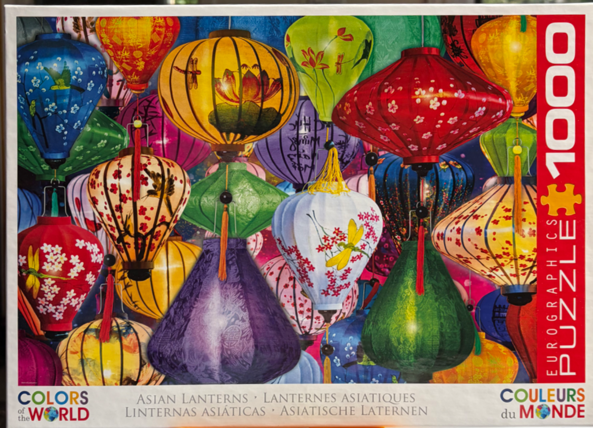 A dense collection of colorful, glowing Asian silk lanterns in various shapes and sizes.