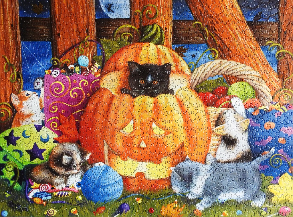 A group of kittens playing around a large Jack-o'-lantern and Halloween treats in a whimsical, colorful illustration.