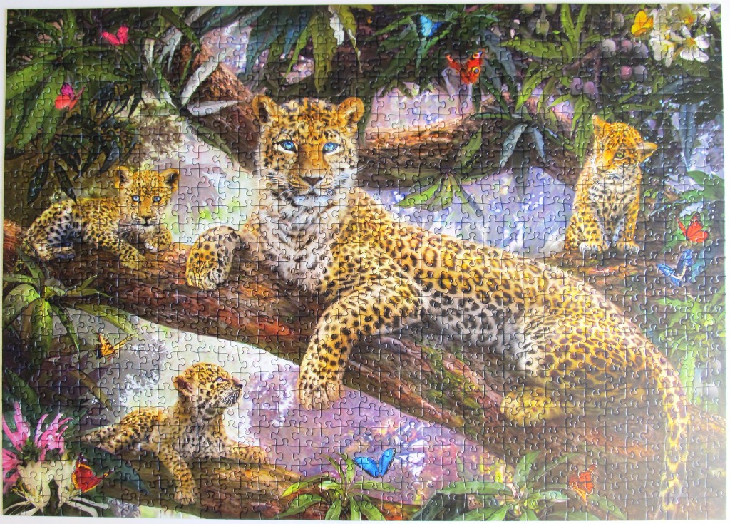A mother leopard and three cubs resting on a tree branch in a vibrant jungle setting with butterflies.