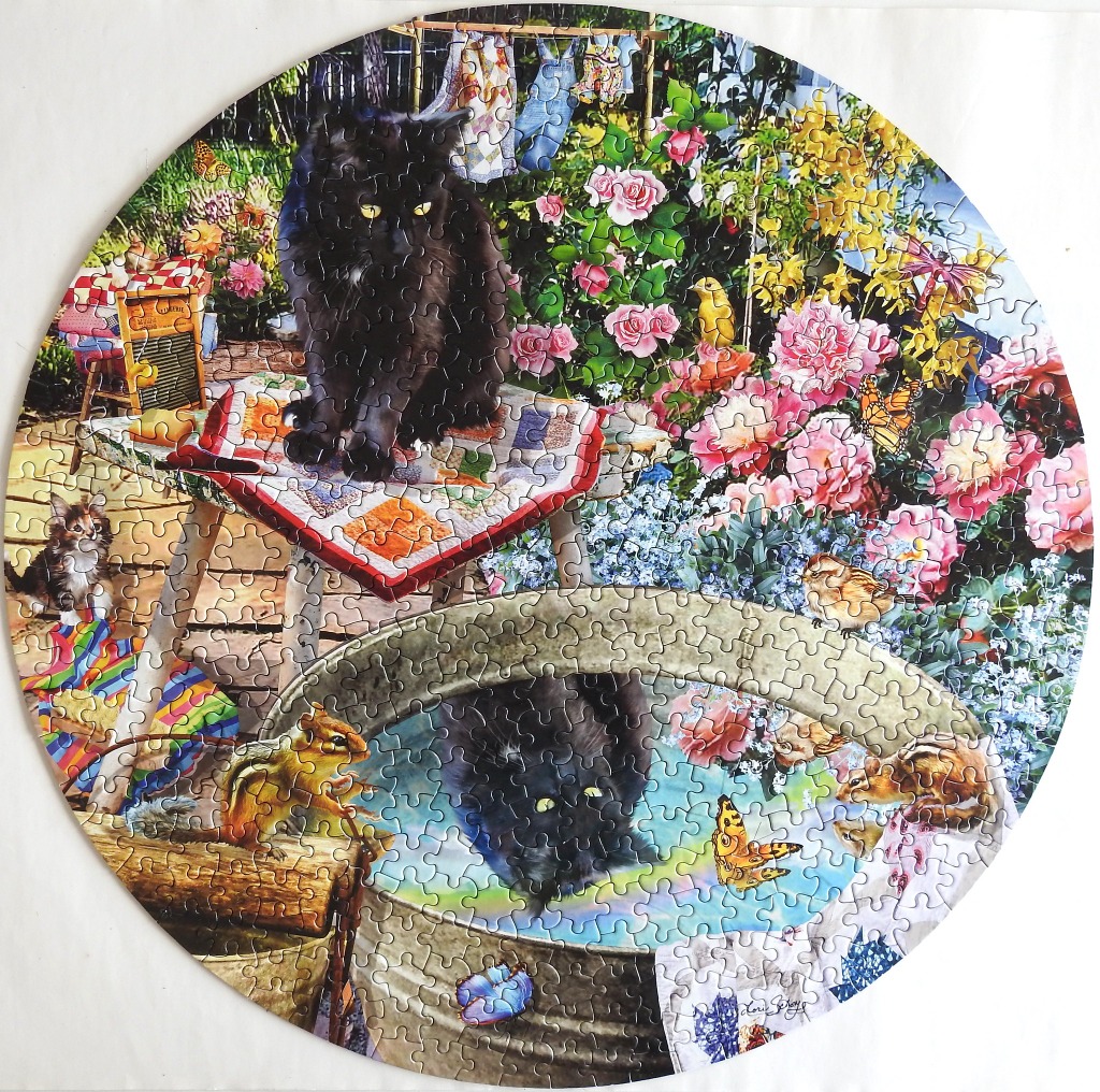 A black cat sitting on a stool next to a garden birdbath with a chipmunk, flowers, and butterflies.