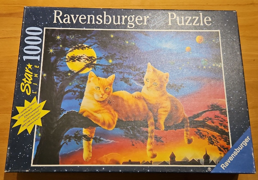 Two ginger kittens perched on a tree branch against a sunset sky with a full moon and stars.