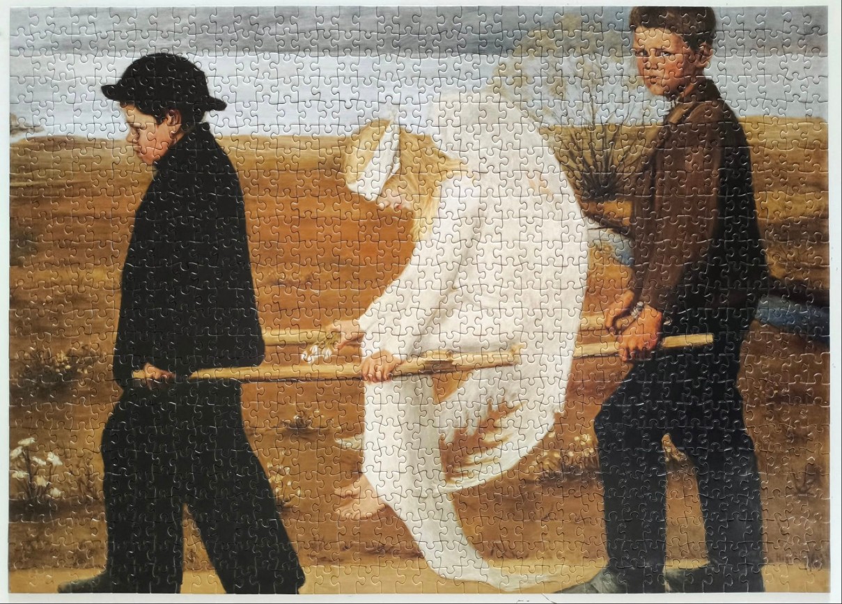 Two young men in dark clothing carry a girl in a white dress through a barren landscape.