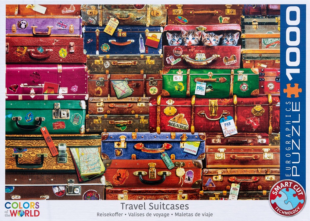A tall, crowded stack of vintage travel suitcases adorned with travel stickers and tags, featuring kittens peering out.