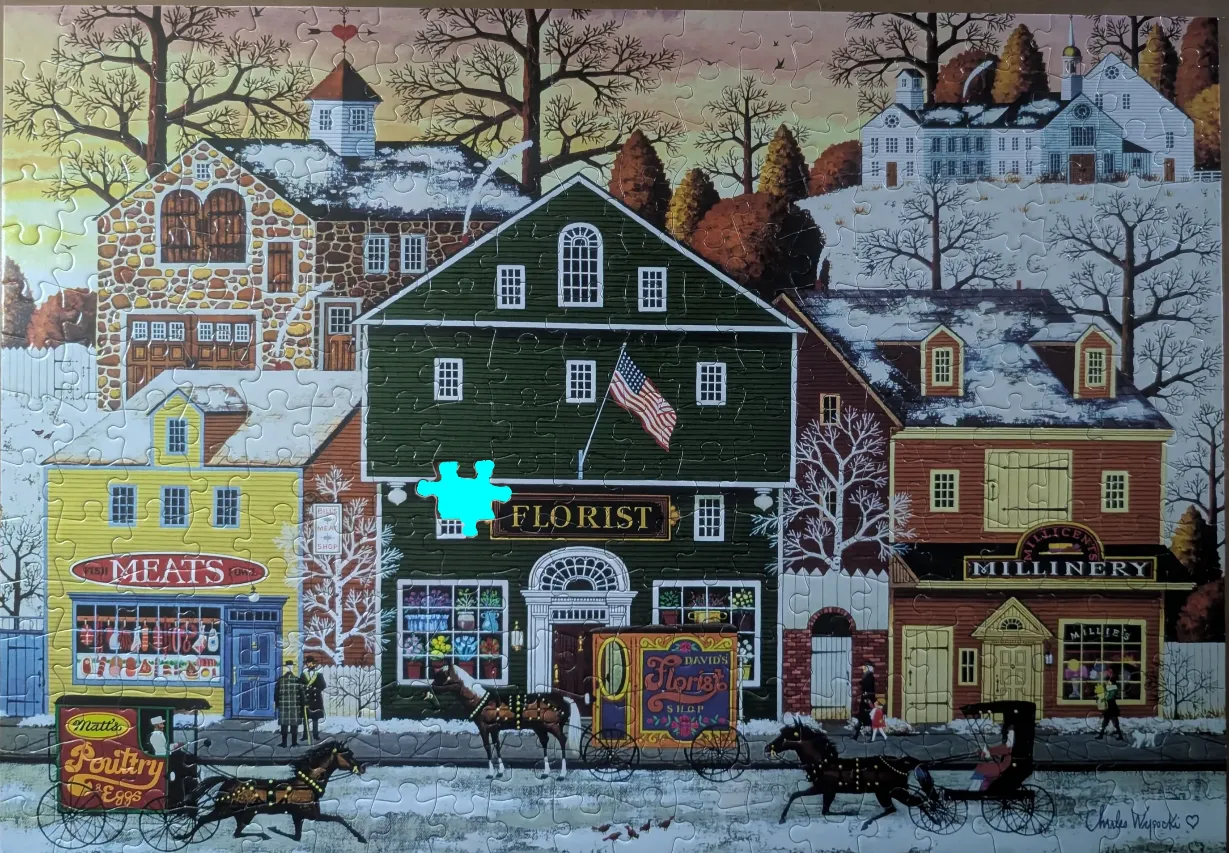 A snowy winter street scene featuring a florist shop, meat market, and millinery shop with horse-drawn carriages.