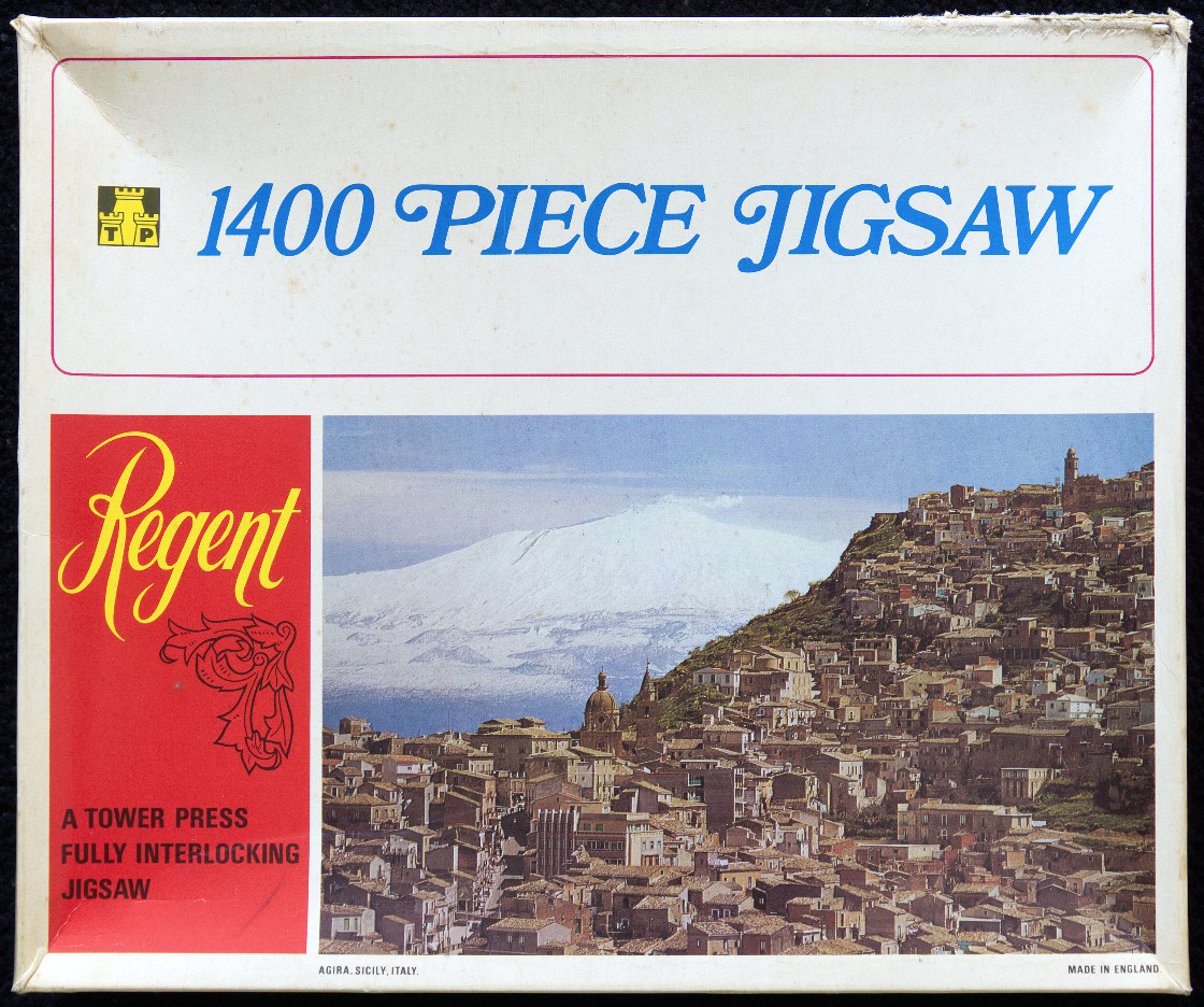 A photograph of the hillside town of Agira, Sicily, featuring Mount Etna in the background.