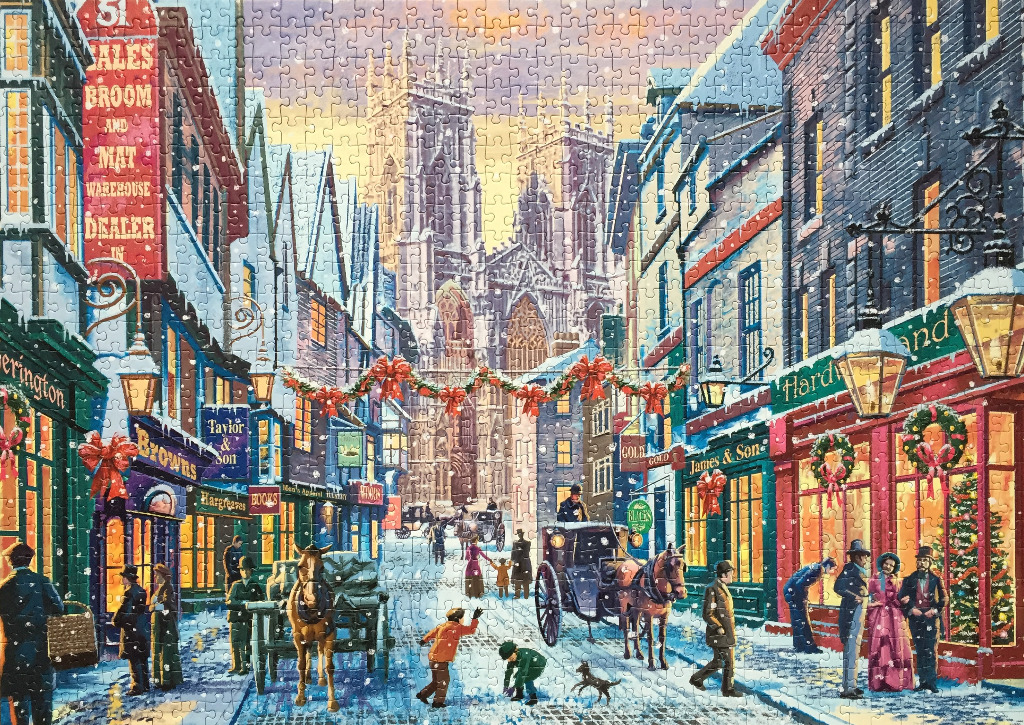 A Victorian-style city street scene at Christmas with a large cathedral in the background.