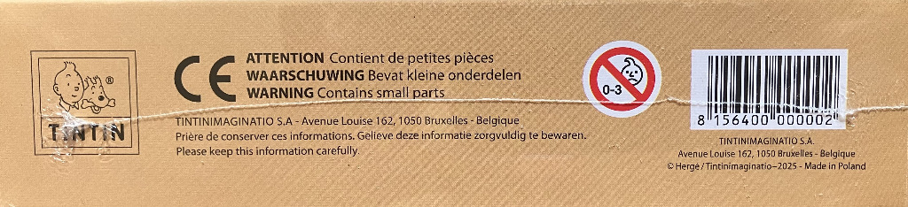 A tan surface featuring the Tintin logo, warning text, a child-safety symbol, and a barcode.