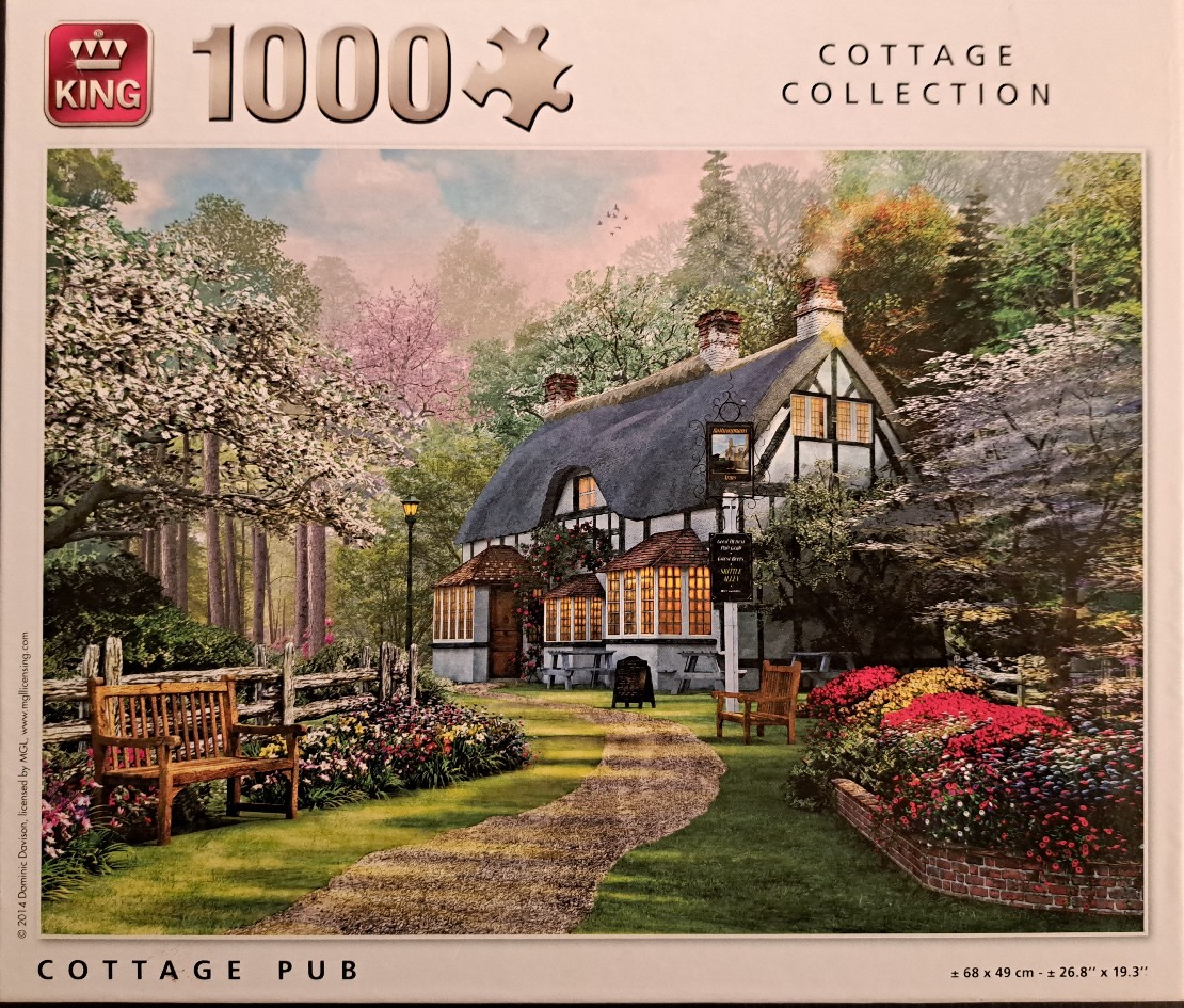 A thatched-roof English cottage pub set in a lush, floral garden at twilight.