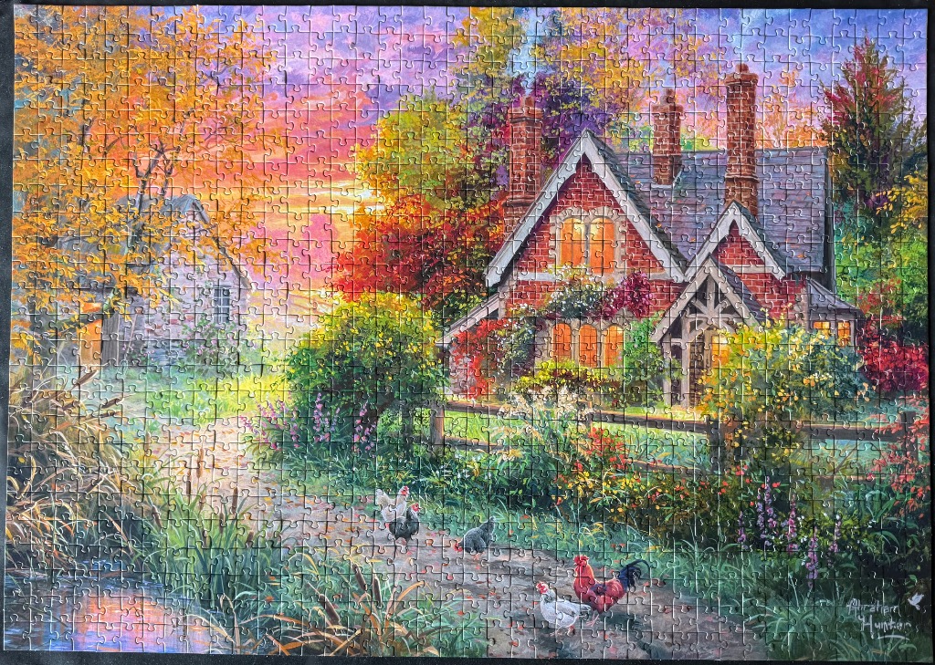 A countryside cottage scene at sunset with chickens on a path.