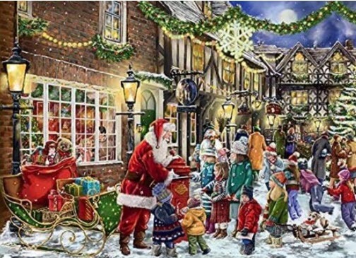Santa Claus interacting with children in a snow-covered, festive town square at night.