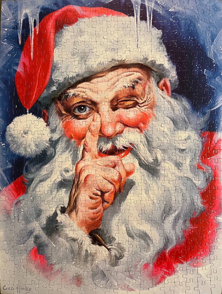 Close-up illustration of Santa Claus holding a finger to his lips in a shushing gesture against a wintery blue background.