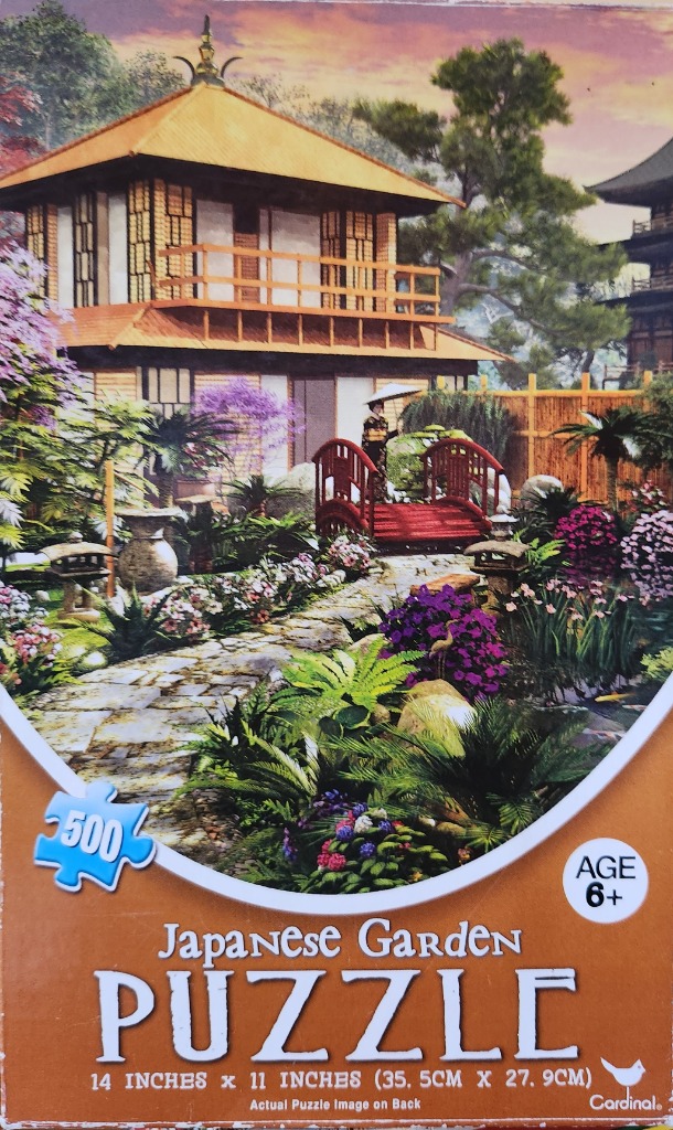 A traditional Japanese garden scene with a wooden pavilion, a small arched bridge, and a person holding a parasol.