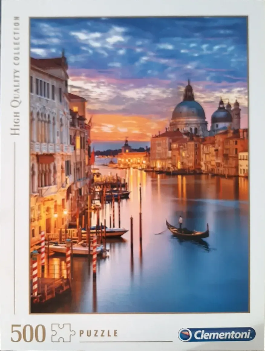 Venetian canal scene at sunset with Santa Maria della Salute in the background.