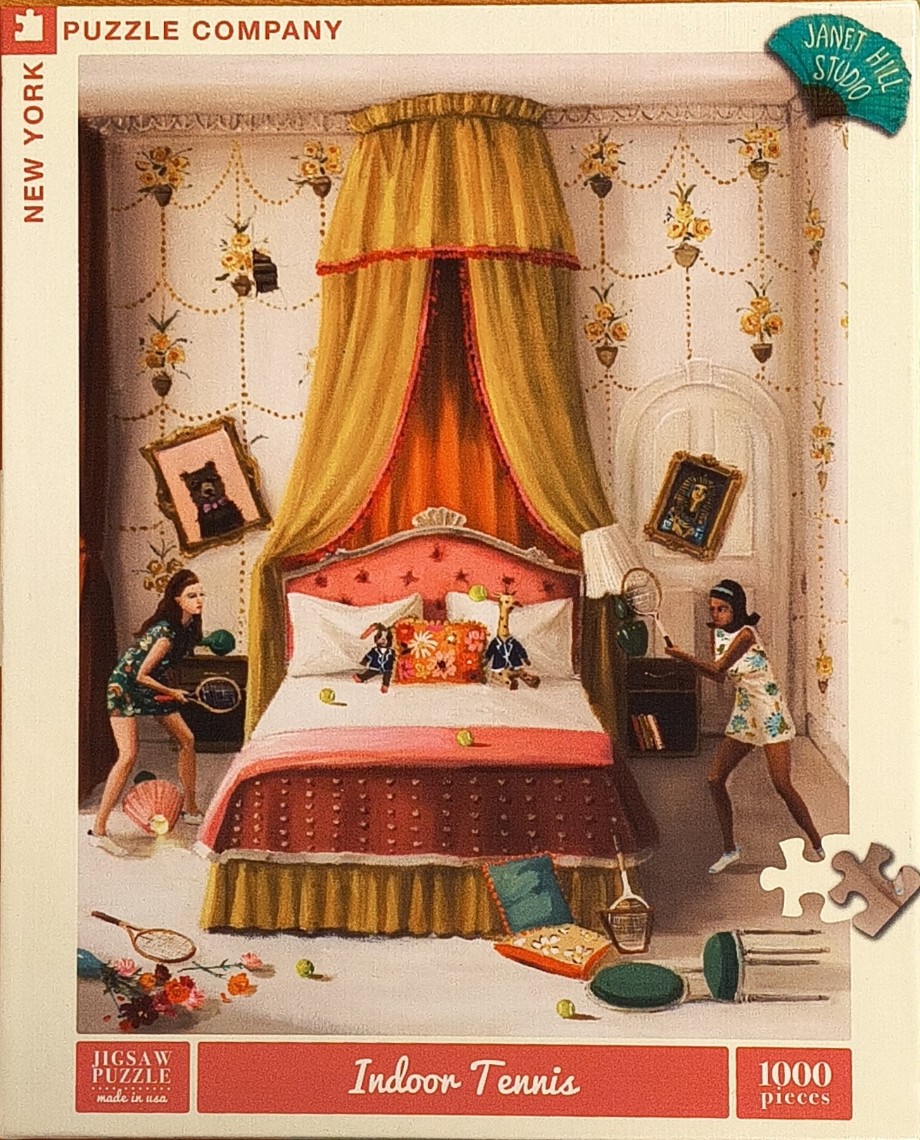 Two young women playing tennis inside an opulent bedroom with a large canopy bed.