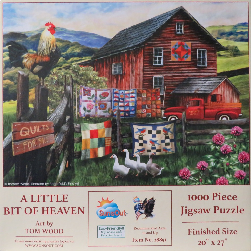 A rural farm scene featuring a red barn, a rooster on a fence, and colorful quilts hanging on a clothesline.