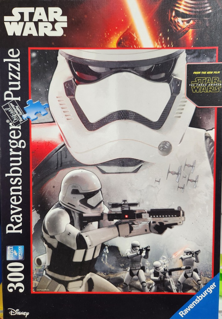 A Star Wars scene featuring a giant First Order Stormtrooper helmet and a squad of Stormtroopers in combat.