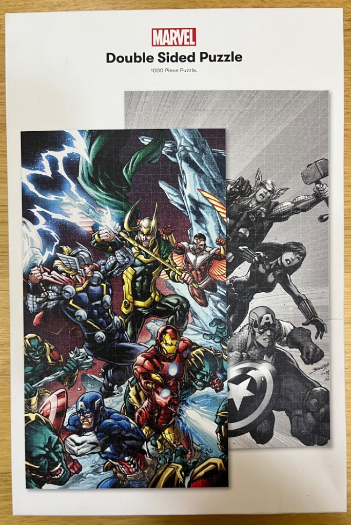 A double-sided illustration of Marvel superheroes, one side in vibrant color and the other in grayscale comic style.