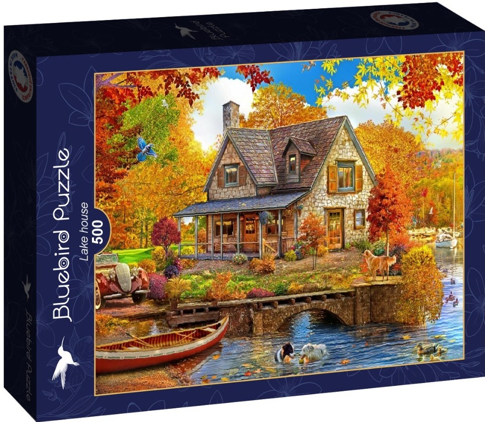 A cozy stone house by a lake in autumn with a vintage car, dogs, and a red canoe.