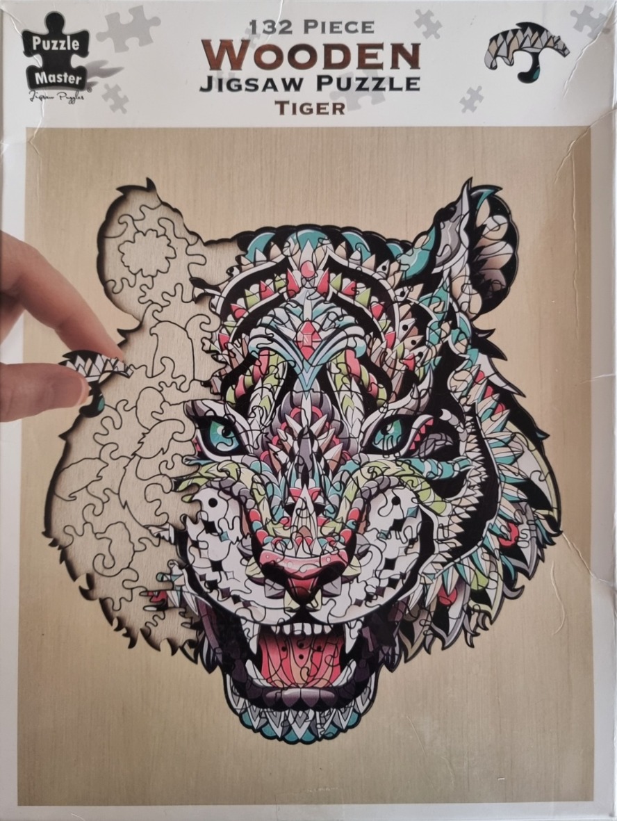 A tiger portrait stylized with intricate, multi-colored geometric patterns on a natural wood background.