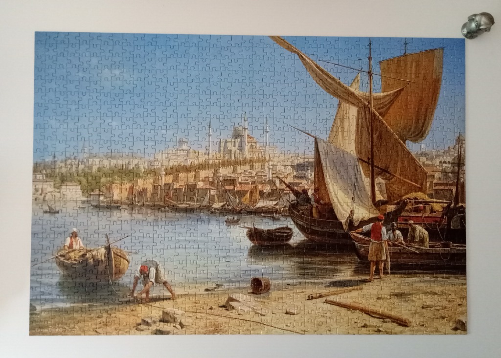 A painting of a harbor scene with traditional boats and a mosque in the background.