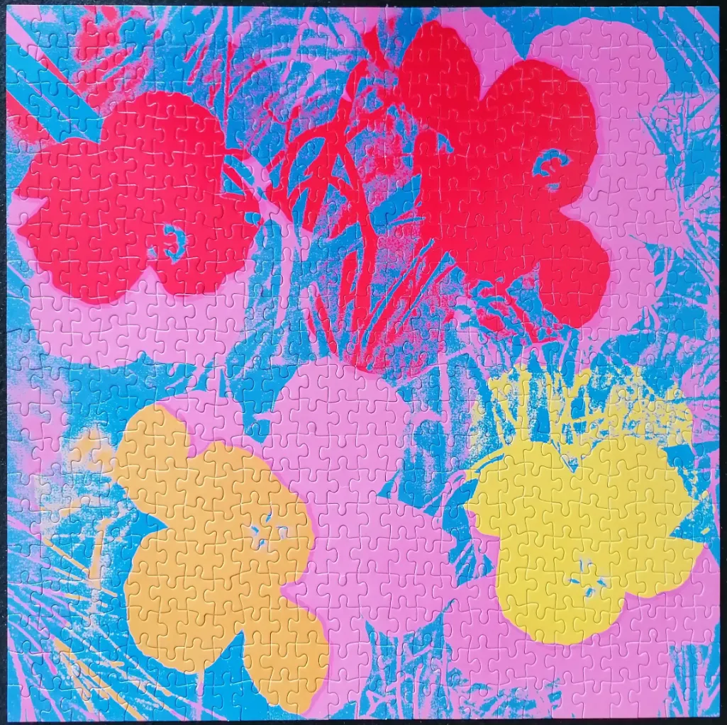 Stylized floral print in bold, high-contrast pop art style with pink, red, yellow, and bright blue colours.