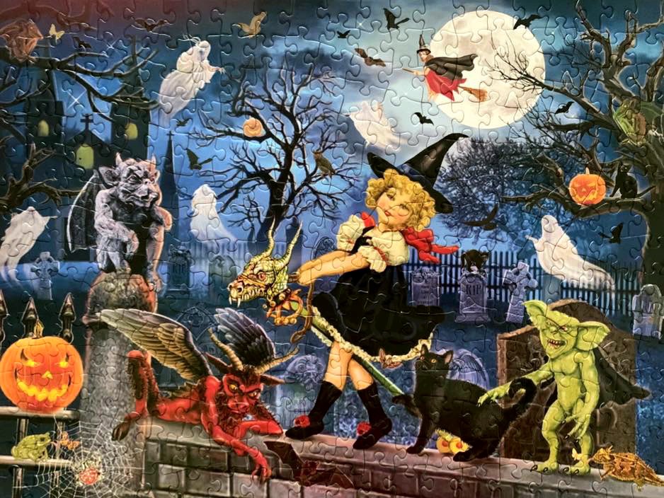 A whimsical Halloween scene featuring a young witch, a gargoyle, and goblins in a graveyard under a full moon.