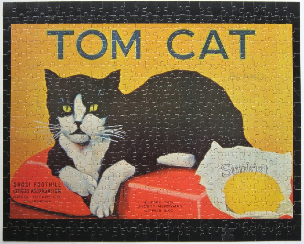 Vintage-style fruit crate label illustration of a black and white cat named Tom Cat