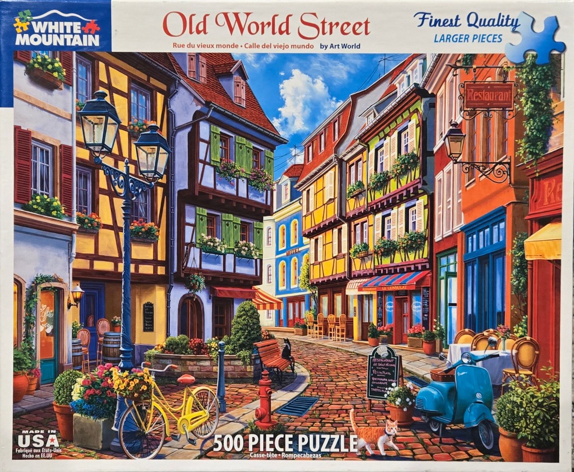 A charming European-style street scene featuring half-timbered buildings, flower boxes, a bright blue scooter, and a cat.