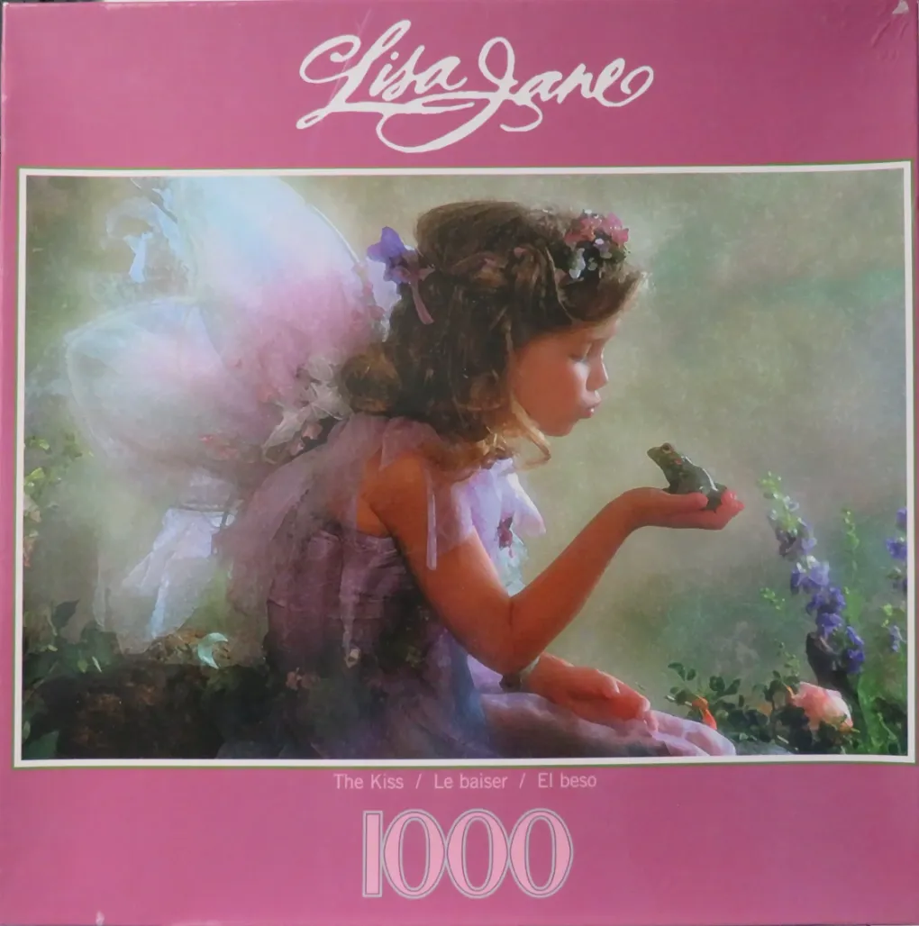 A young girl dressed as a fairy gently blowing a kiss to a small green frog in a misty garden setting.
