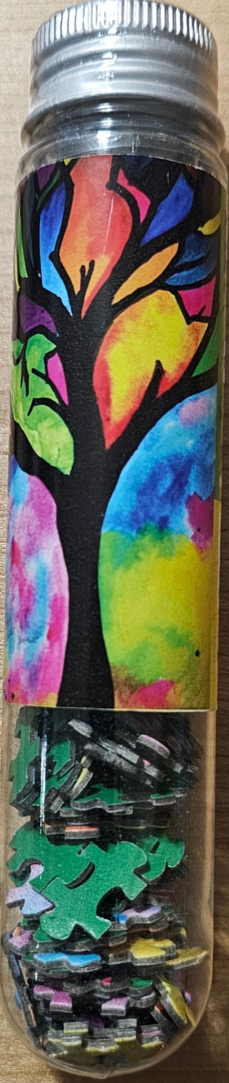 A stained-glass style artwork of a vibrant, multi-colored tree on a clear tube.