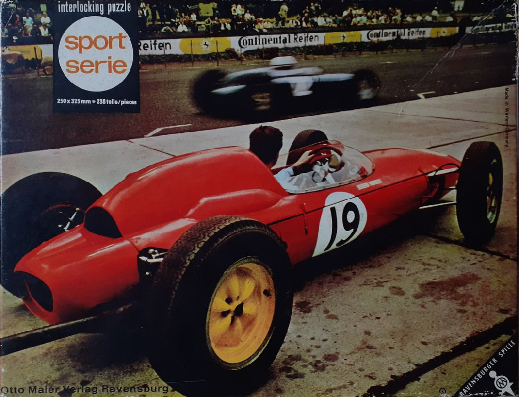 Vintage red race car with number 19 on a track during a competition
