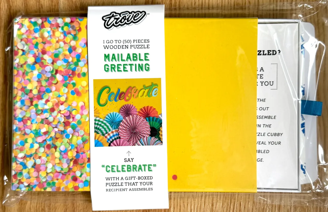 A festive design featuring colorful confetti and pleated paper fans below the word Celebrate.