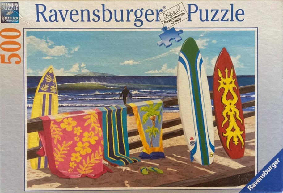 Painting of surfboards, colorful beach towels on a wooden railing, and a surfer in the distance at a sunny beach.