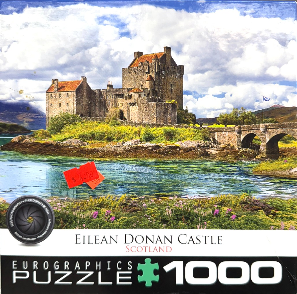 Eilean Donan Castle in Scotland surrounded by water and lush greenery under a bright, cloudy sky.