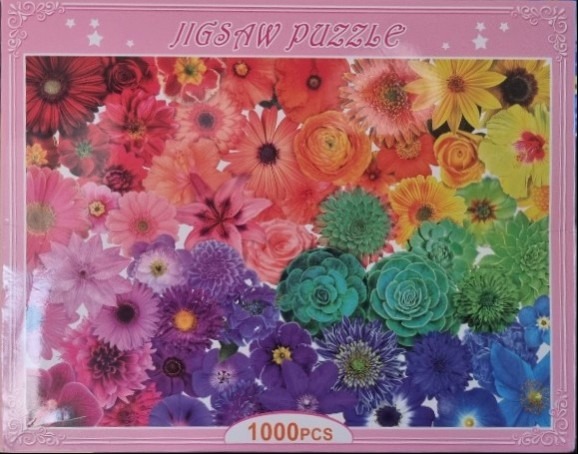 A vibrant collage of flowers arranged in a spectrum from red and pink to purple, green, and blue.