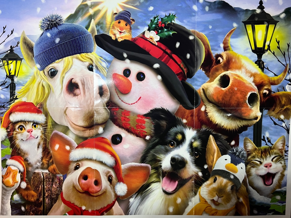 A whimsical collection of animals and a snowman wearing winter accessories in a snowy evening setting.