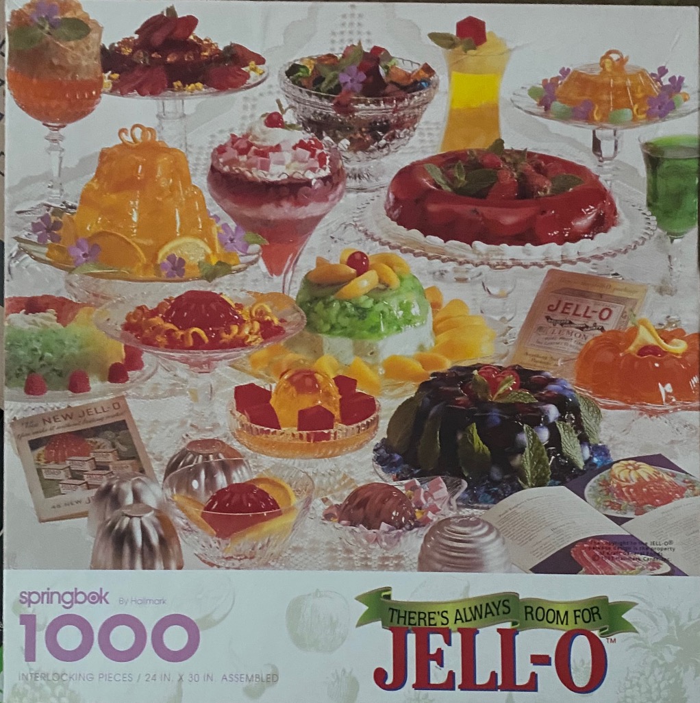 A collection of colorful gelatin desserts served in various glass dishes on a table.
